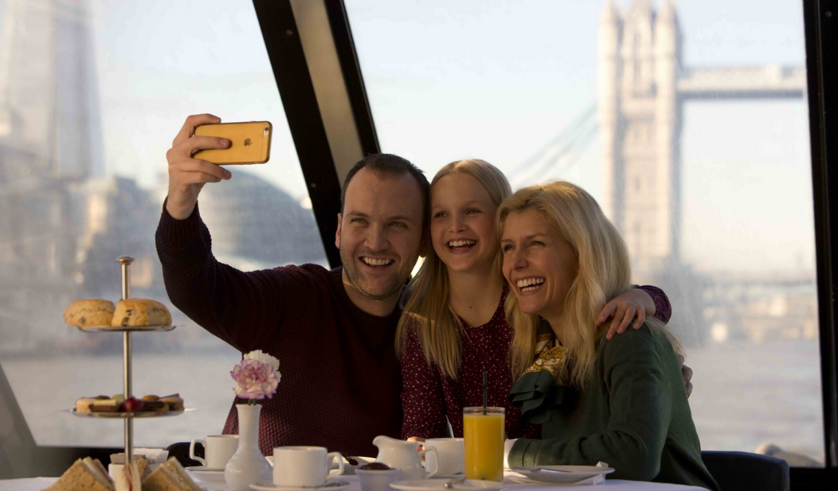 A family have afternoon tea while on board City Cruises